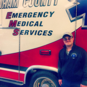 David standing in front of EMS truck