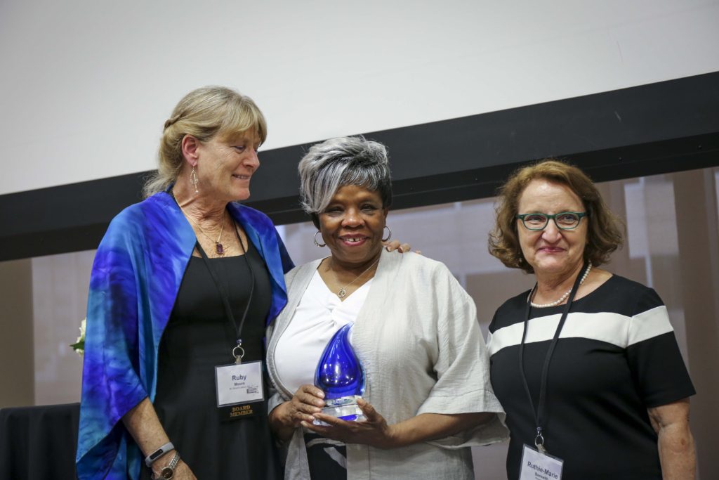 (left to right) Ruby Moore, Barbara Ransom, and Ruthie-Marie Beckwith pose for a photo after Barbara Ransom was presented with her award.